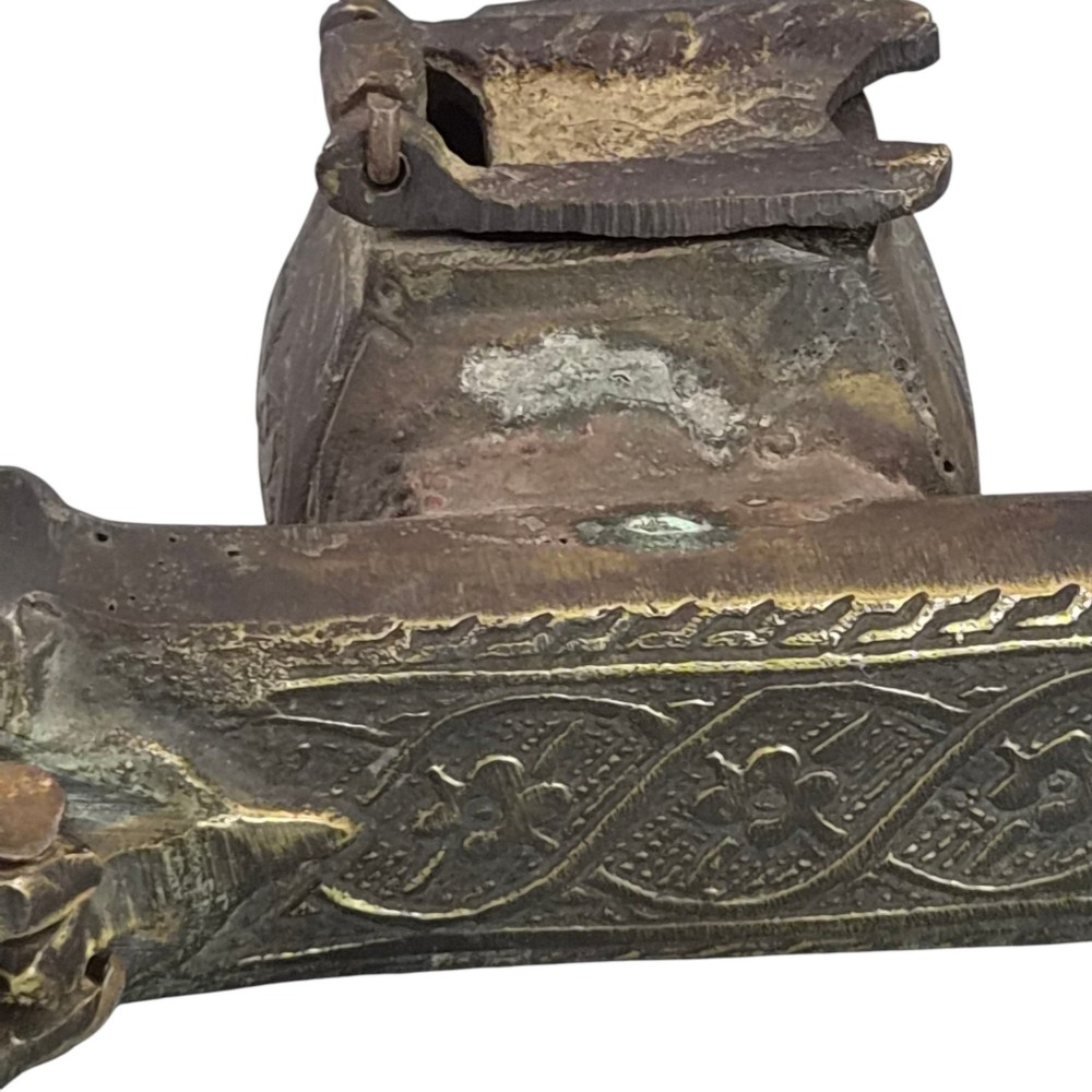 An antique cast and engraved brass travelling pen case and integrated inkwell featuring ornate scrollwork patterns and script. View VIII