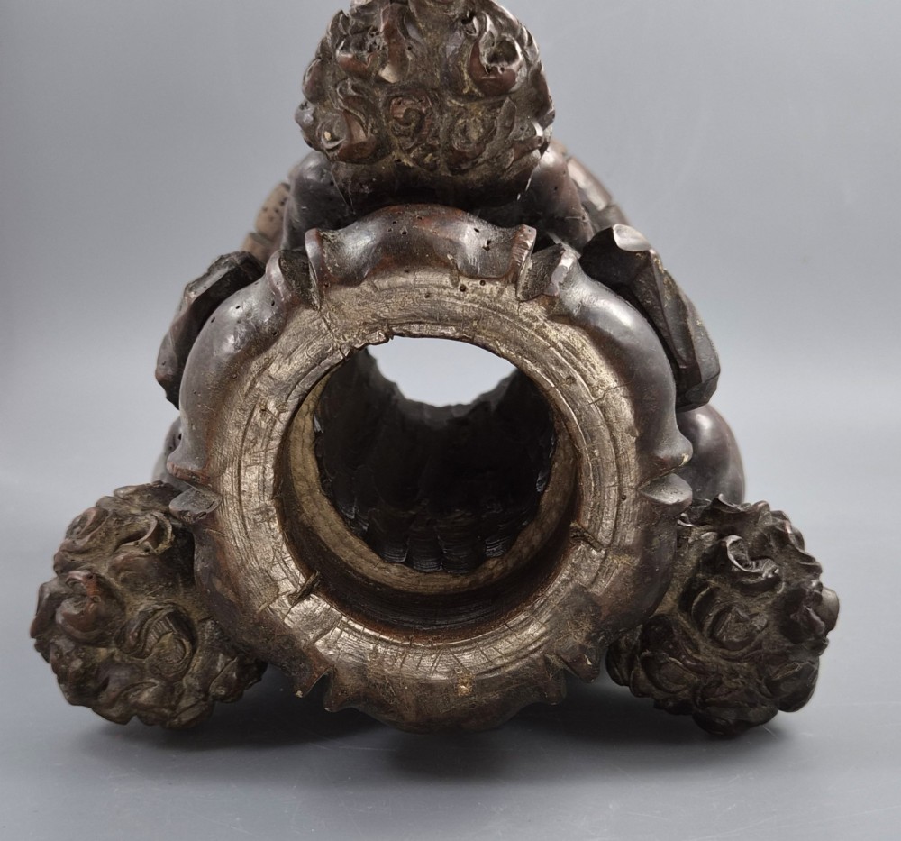 A dark carved walnut Italian Baroque torchiere base featuring three sculpted putti figures standing around a central fluted shaft on a gadrooned circular base. View IX