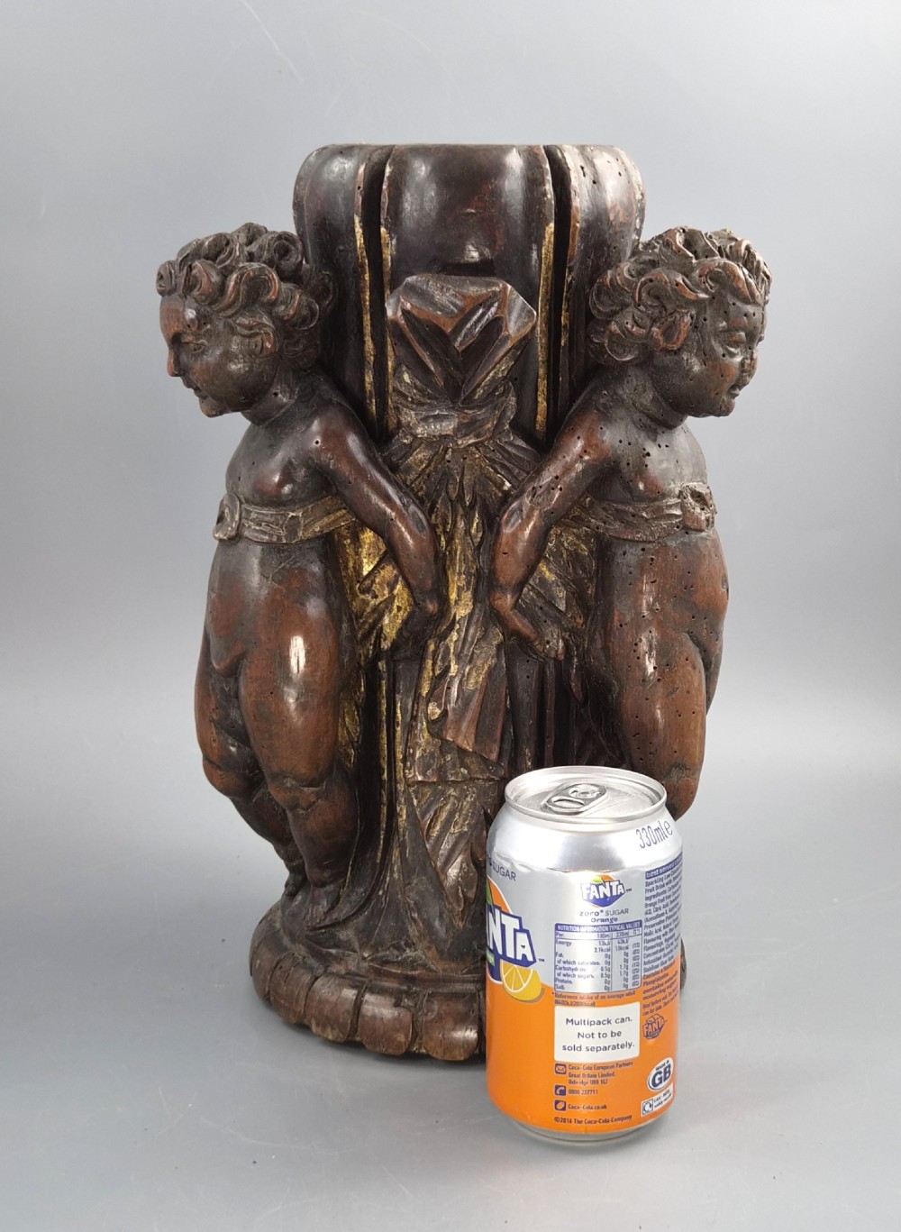 A dark carved walnut Italian Baroque torchiere base featuring three sculpted putti figures standing around a central fluted shaft on a gadrooned circular base. View XV