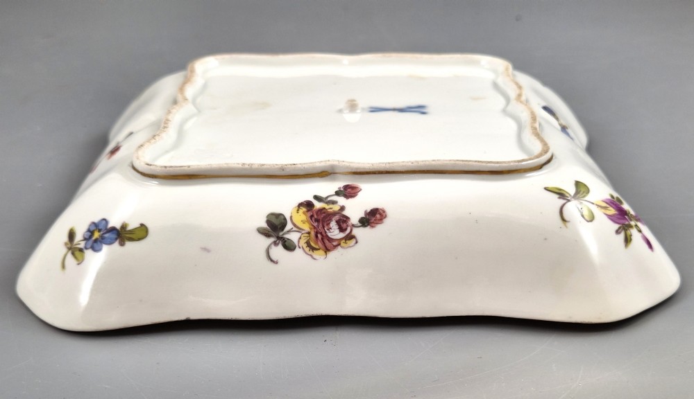 A square shaped Meissen porcelain dish decorated with hand-painted Watteau scenes, floral reserves on a black ground, and gilded scroll borders. View XI