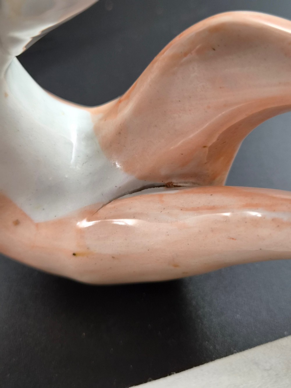 A pair of antique Victorian Staffordshire earthenware figures depicting standing orange greyhounds holding grey hares in their jaws on white bases. View XIII