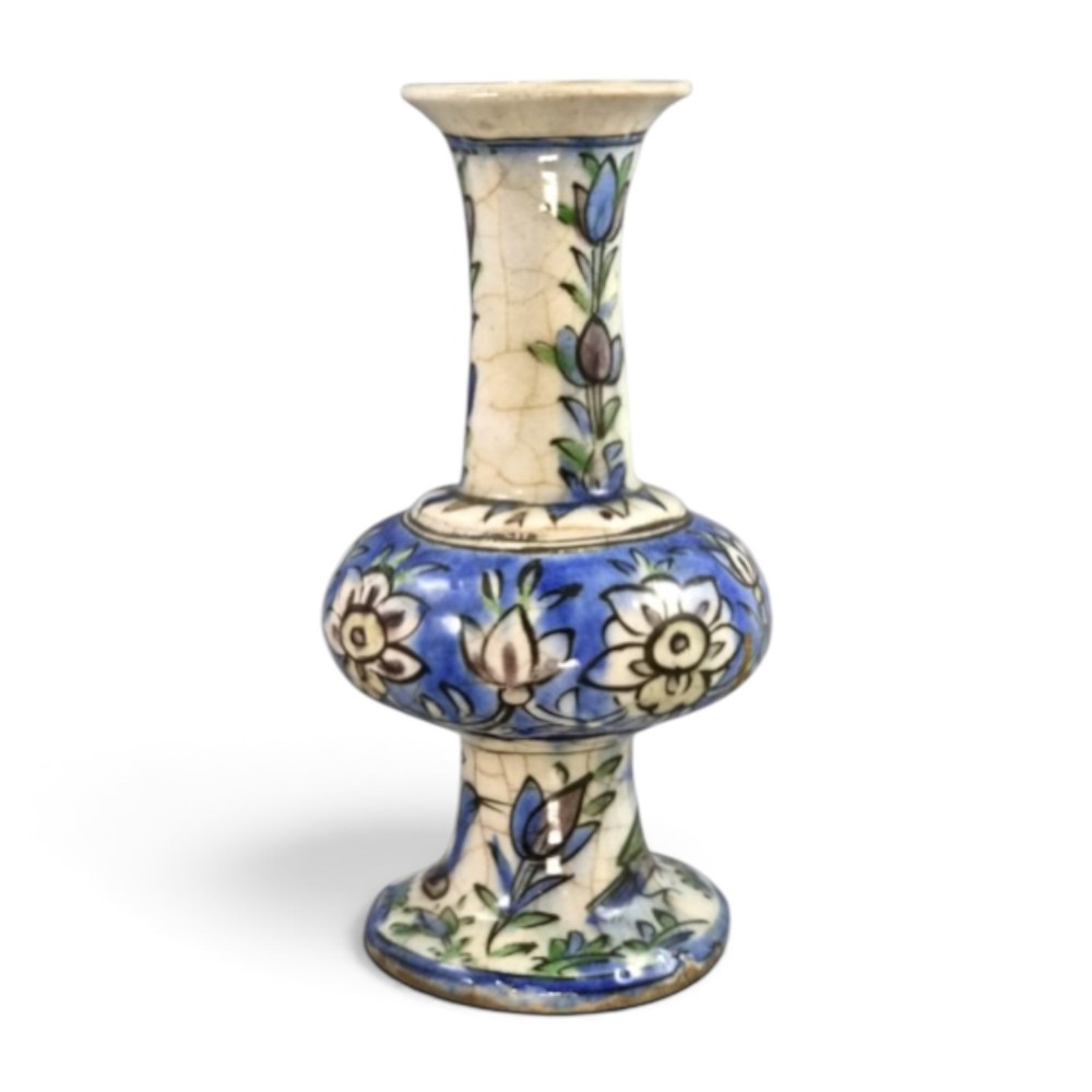 A late Qajar Persian polychrome ceramic vase featuring a central bulbous knop, flared rim, crackle glaze finish, and painted blue and green floral motifs.