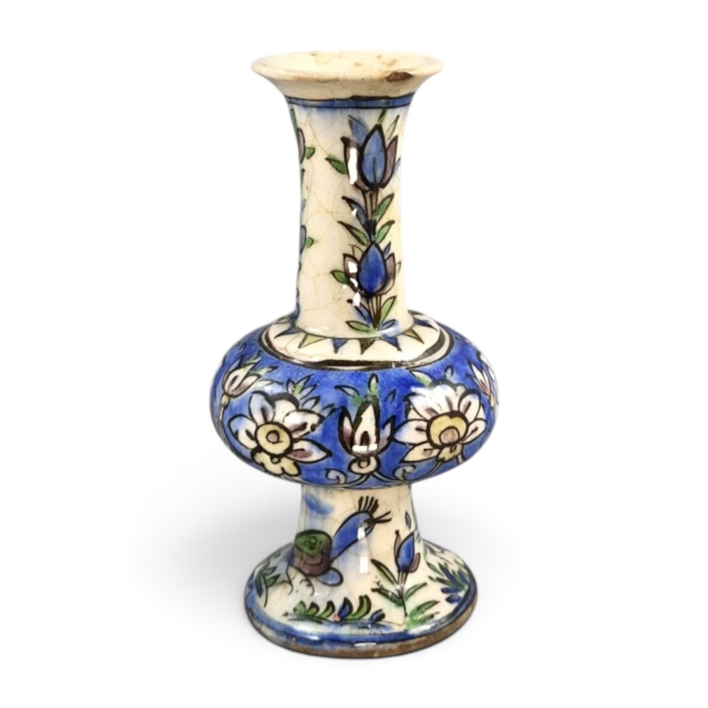 A late Qajar Persian polychrome ceramic vase featuring a central bulbous knop, flared rim, crackle glaze finish, and painted blue and green floral motifs. View III