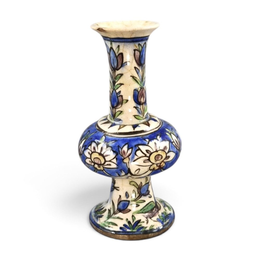 A late Qajar Persian polychrome ceramic vase featuring a central bulbous knop, flared rim, crackle glaze finish, and painted blue and green floral motifs. View IV