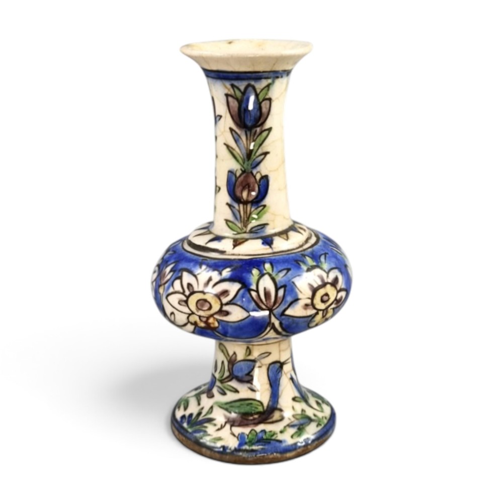 A late Qajar Persian polychrome ceramic vase featuring a central bulbous knop, flared rim, crackle glaze finish, and painted blue and green floral motifs. View V