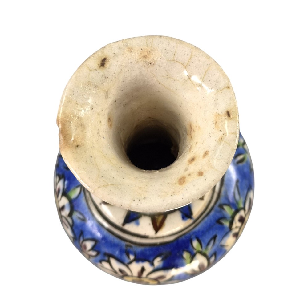 A late Qajar Persian polychrome ceramic vase featuring a central bulbous knop, flared rim, crackle glaze finish, and painted blue and green floral motifs. View VI