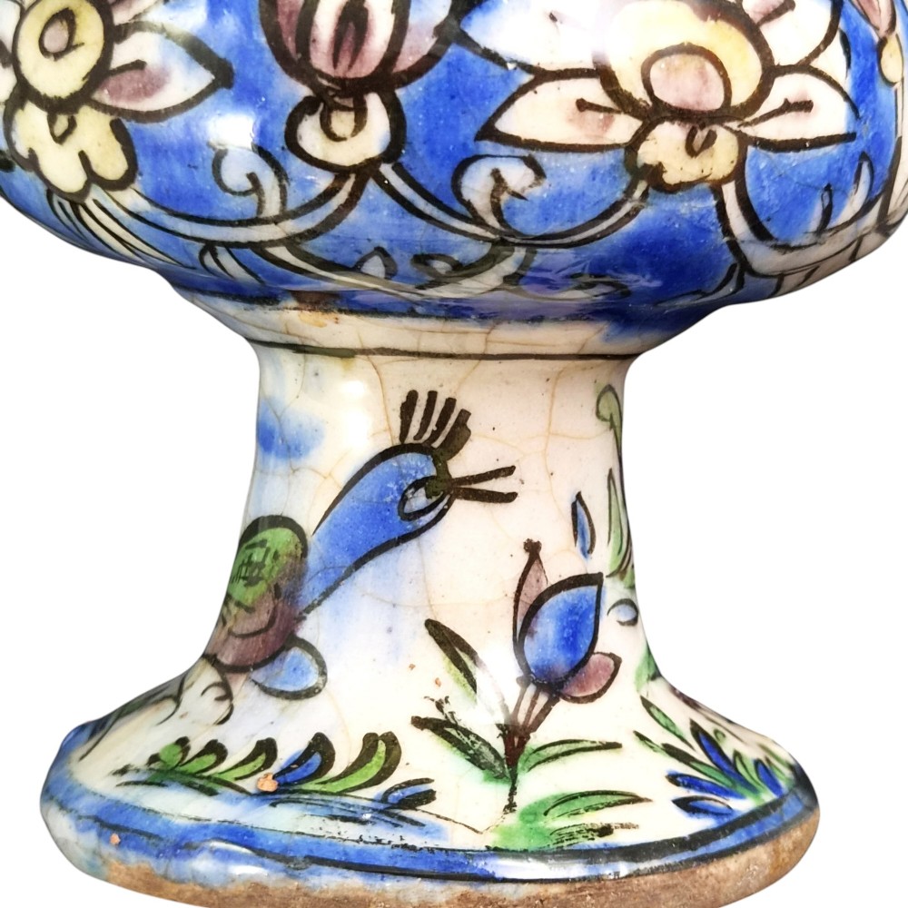 A late Qajar Persian polychrome ceramic vase featuring a central bulbous knop, flared rim, crackle glaze finish, and painted blue and green floral motifs. View XI