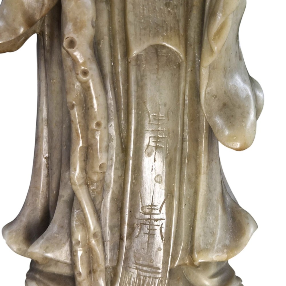 A late 19th-century carved pale soapstone figure of Shoulao holding a peach and staff, standing on a dark stone pierced rockwork base. View IX