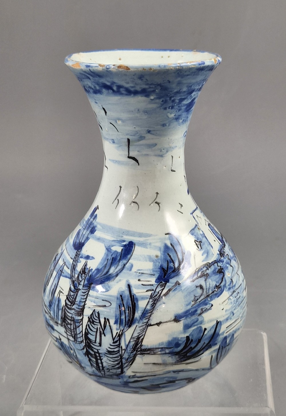 An antique bulbous blue and white maiolica ceramic vase decorated with a hand-painted architectural landscape scene and a flared rim. View III