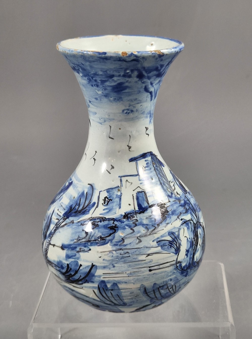 An antique bulbous blue and white maiolica ceramic vase decorated with a hand-painted architectural landscape scene and a flared rim. View IV