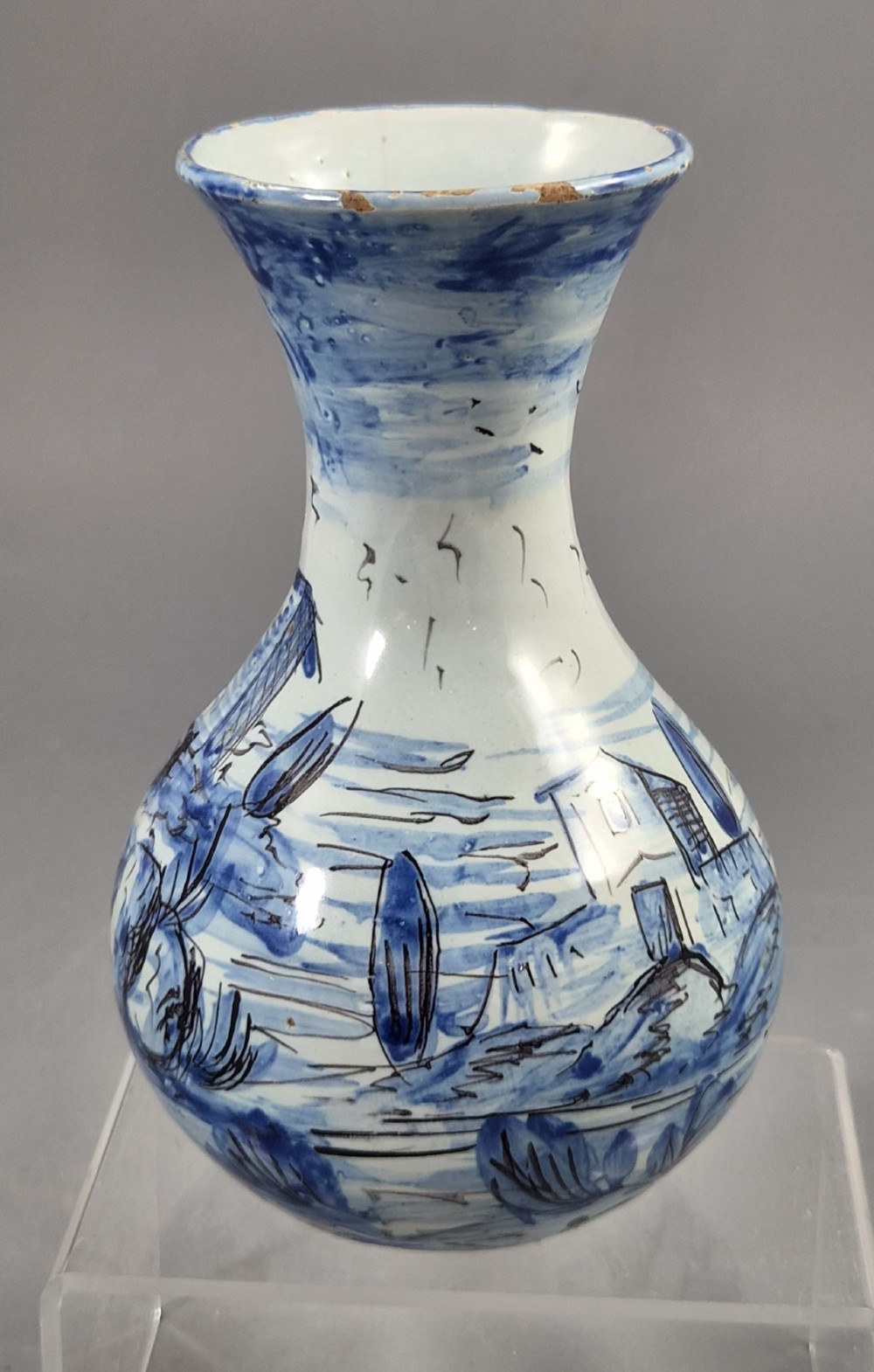 An antique bulbous blue and white maiolica ceramic vase decorated with a hand-painted architectural landscape scene and a flared rim. View VI