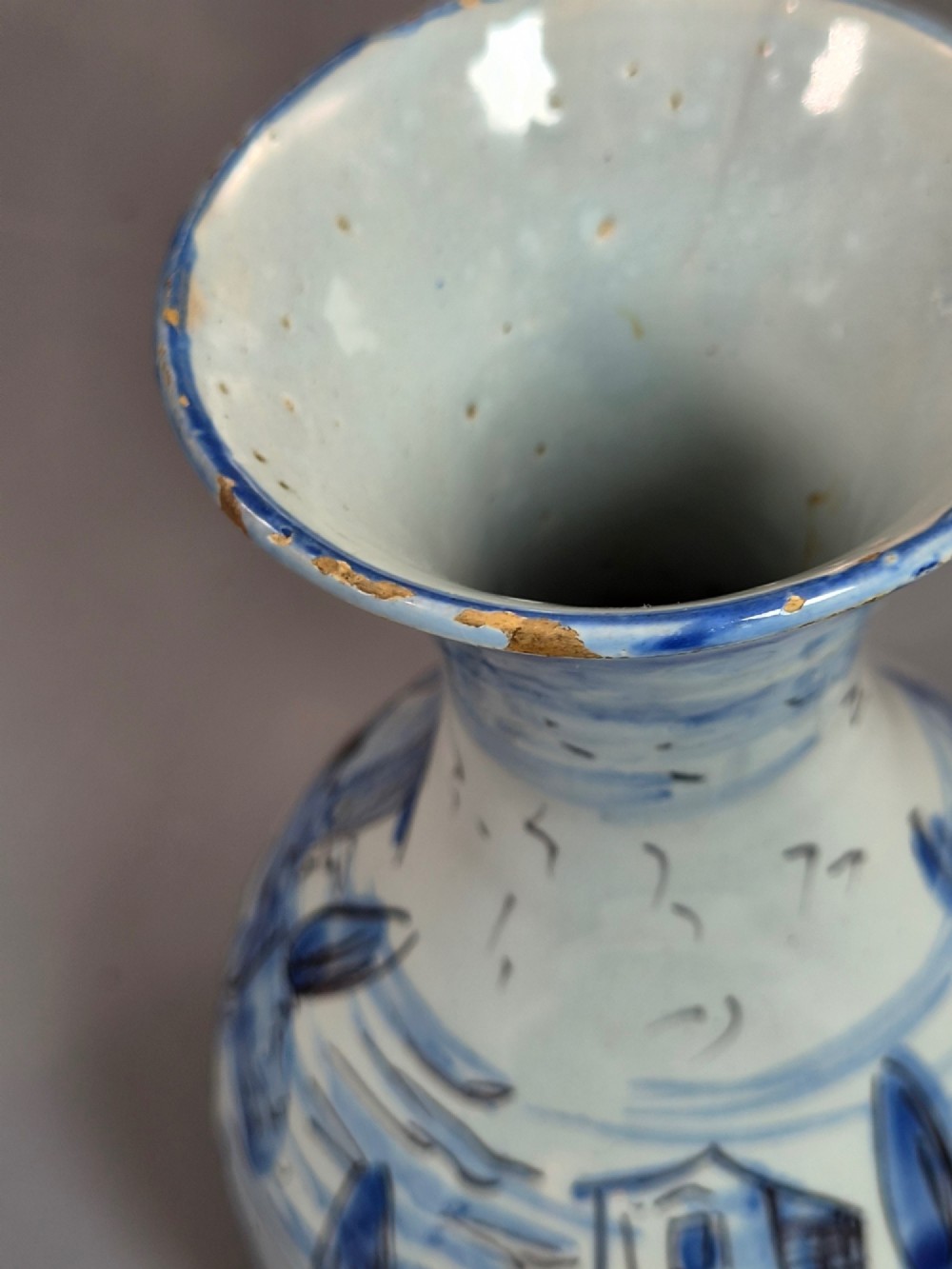 An antique bulbous blue and white maiolica ceramic vase decorated with a hand-painted architectural landscape scene and a flared rim. View IX