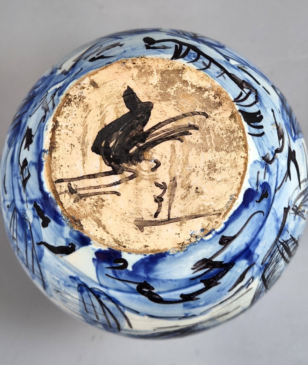 An antique bulbous blue and white maiolica ceramic vase decorated with a hand-painted architectural landscape scene and a flared rim. View XI