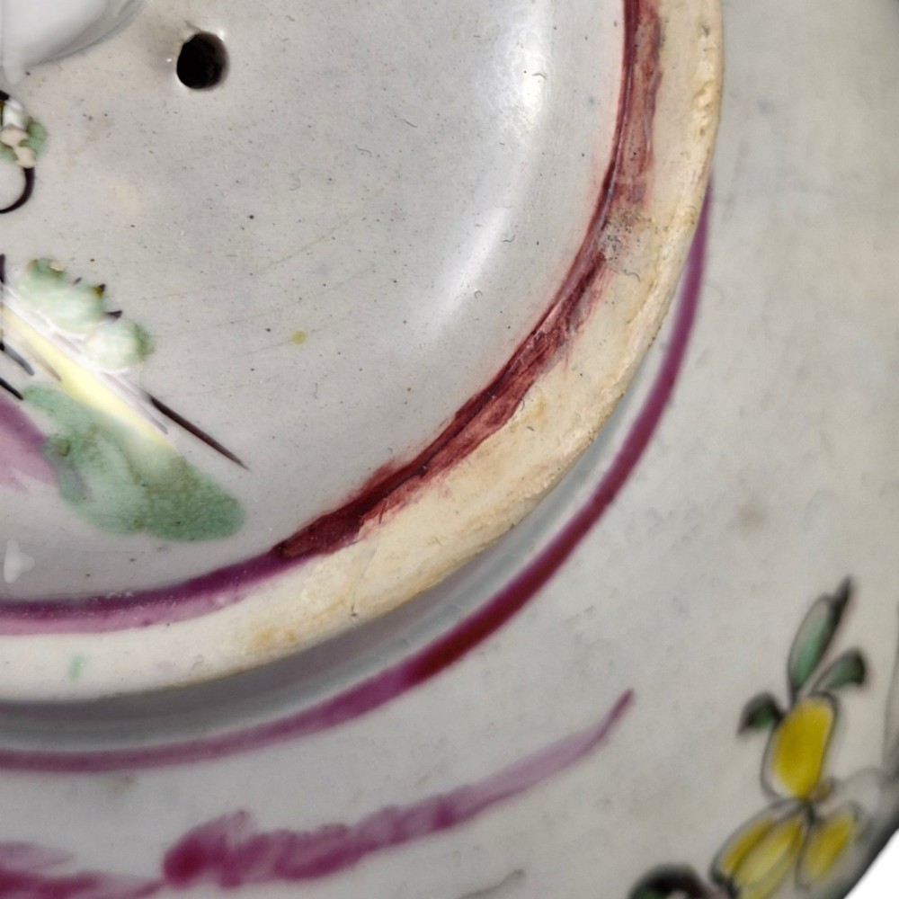 An 18th-century creamware teapot featuring hand-painted polychrome Chinoiserie figures on a cream glaze background with a curved spout and loop handle. View XI