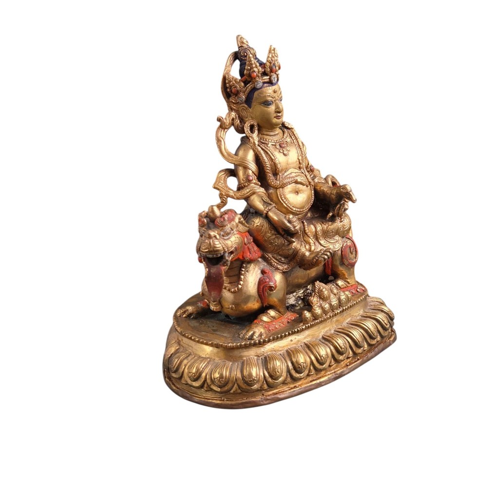 A gilt bronze figure of the deity Jambhala crowned and adorned with jewellery, seated upon a snow lion atop an oval lotus pedestal base with red and blue painted accents. View VIII
