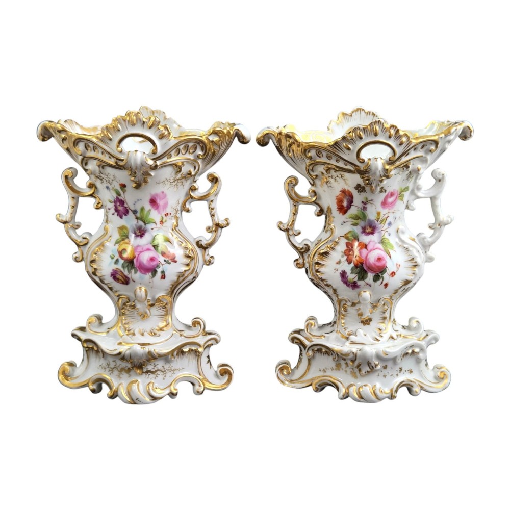 A pair of ornate white and gilded porcelain Rococo vases featuring hand-painted floral bouquets, pierced rims, and scroll handles. View III