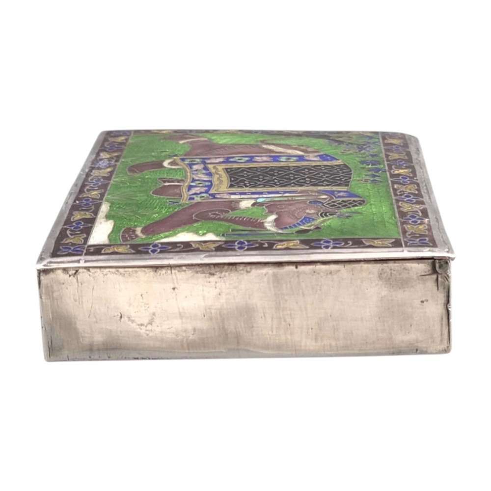 A rectangular sterling silver box featuring a colourful enamelled scene of a decorated Indian elephant set against a green background with a patterned border. View IV