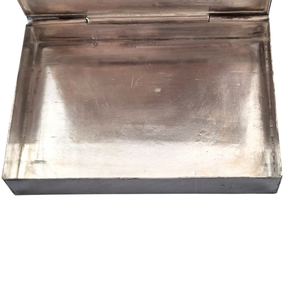 A rectangular sterling silver box featuring a colourful enamelled scene of a decorated Indian elephant set against a green background with a patterned border. View VI
