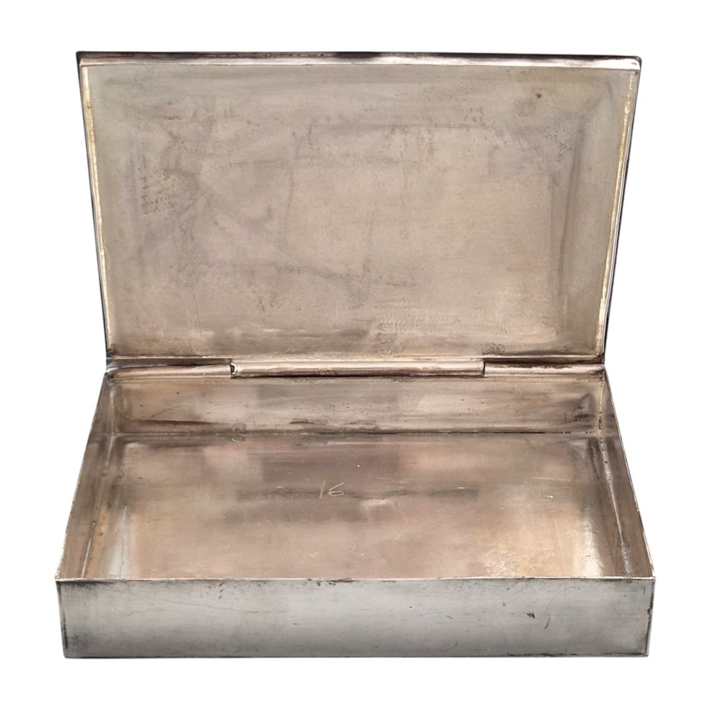 A rectangular sterling silver box featuring a colourful enamelled scene of a decorated Indian elephant set against a green background with a patterned border. View XII