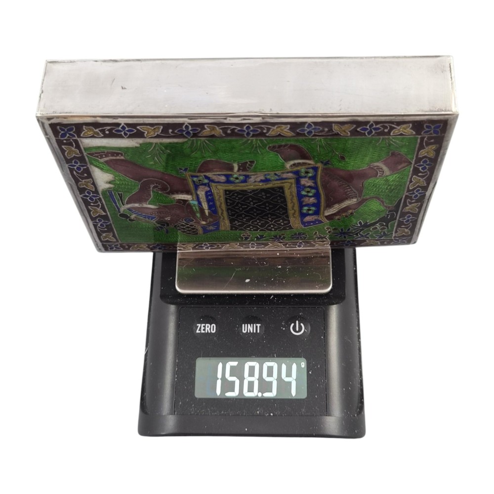 A rectangular sterling silver box featuring a colourful enamelled scene of a decorated Indian elephant set against a green background with a patterned border. View XIII
