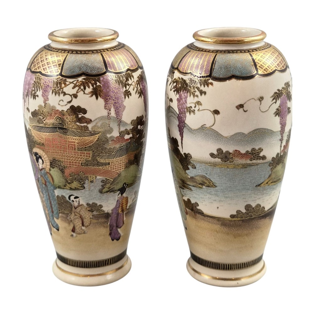 A pair of baluster-shaped Japanese Satsuma earthenware vases decorated with figures of women and children, wisteria flowers, and gold embellishments against a cream crackle glaze background. View II