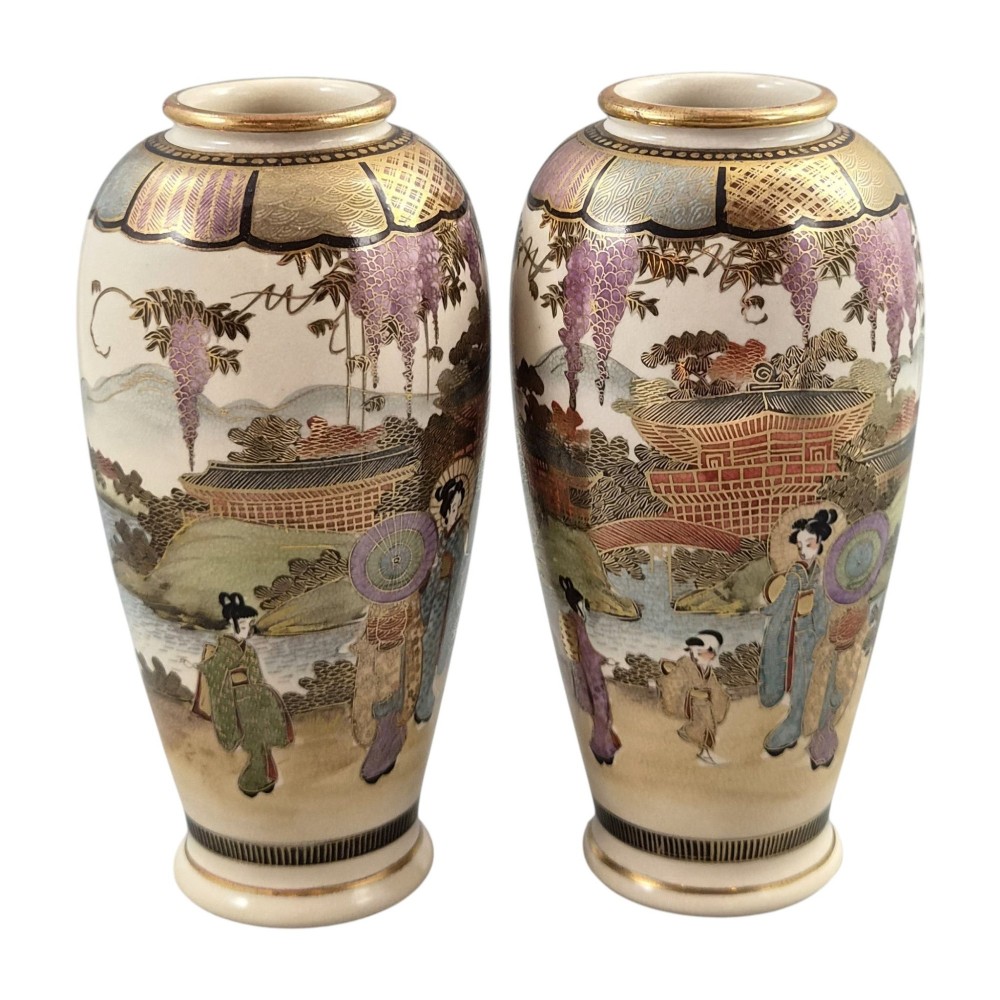 A pair of baluster-shaped Japanese Satsuma earthenware vases decorated with figures of women and children, wisteria flowers, and gold embellishments against a cream crackle glaze background. View XII