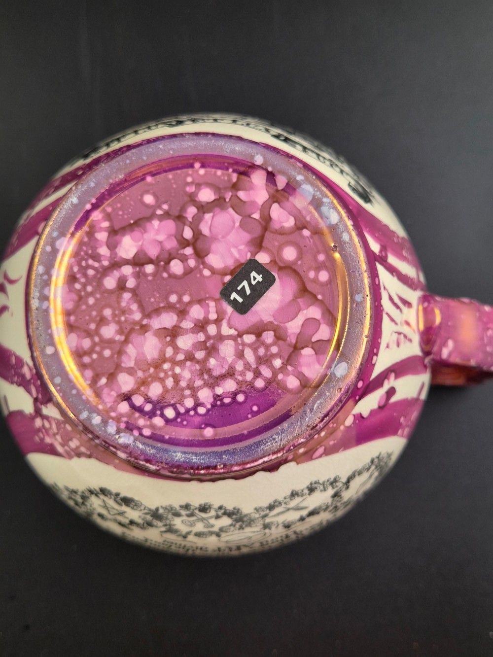 An English earthenware jug featuring pink splash lustre glaze trim and a central black transfer-printed Masonic emblem. View VIII