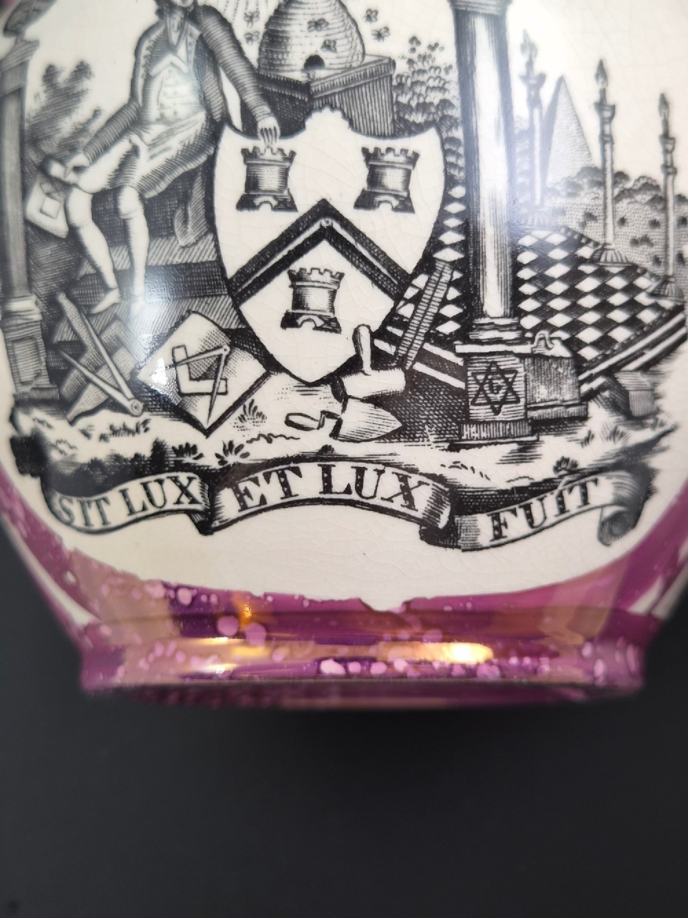 An English earthenware jug featuring pink splash lustre glaze trim and a central black transfer-printed Masonic emblem. View IX