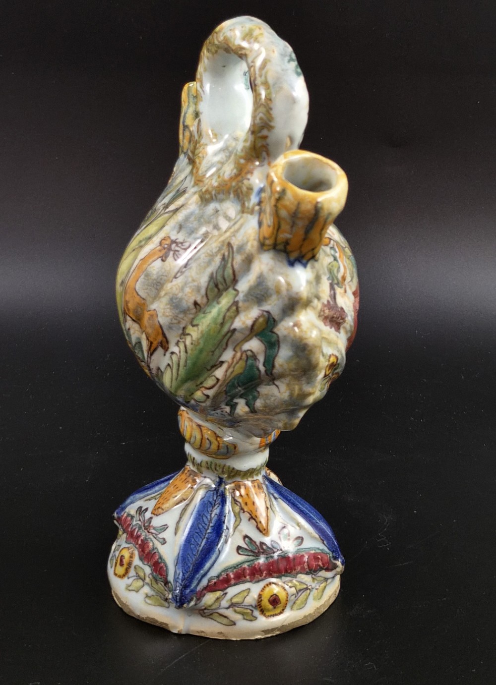 An 18th-century Italian majolica pilgrim flask featuring a scallop-shell body, twin spouts, loop handles, a pedestal foot, and hand-painted polychrome flora and fauna. View V