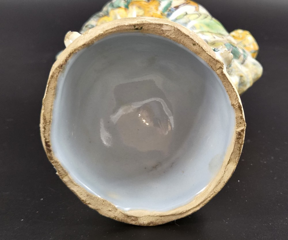 An 18th-century Italian majolica pilgrim flask featuring a scallop-shell body, twin spouts, loop handles, a pedestal foot, and hand-painted polychrome flora and fauna. View IX