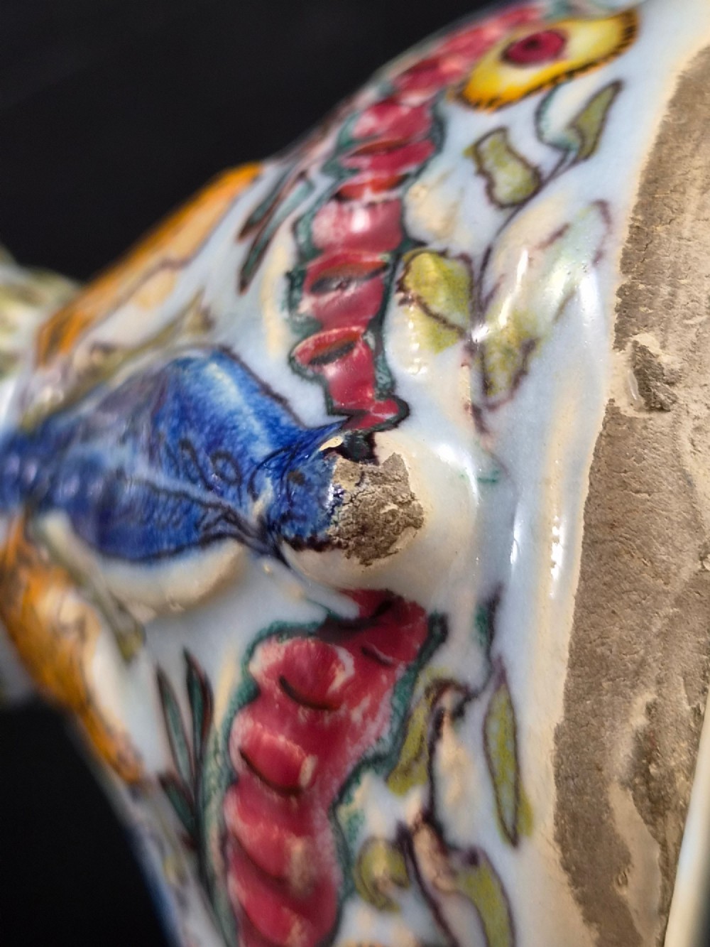 An 18th-century Italian majolica pilgrim flask featuring a scallop-shell body, twin spouts, loop handles, a pedestal foot, and hand-painted polychrome flora and fauna. View X