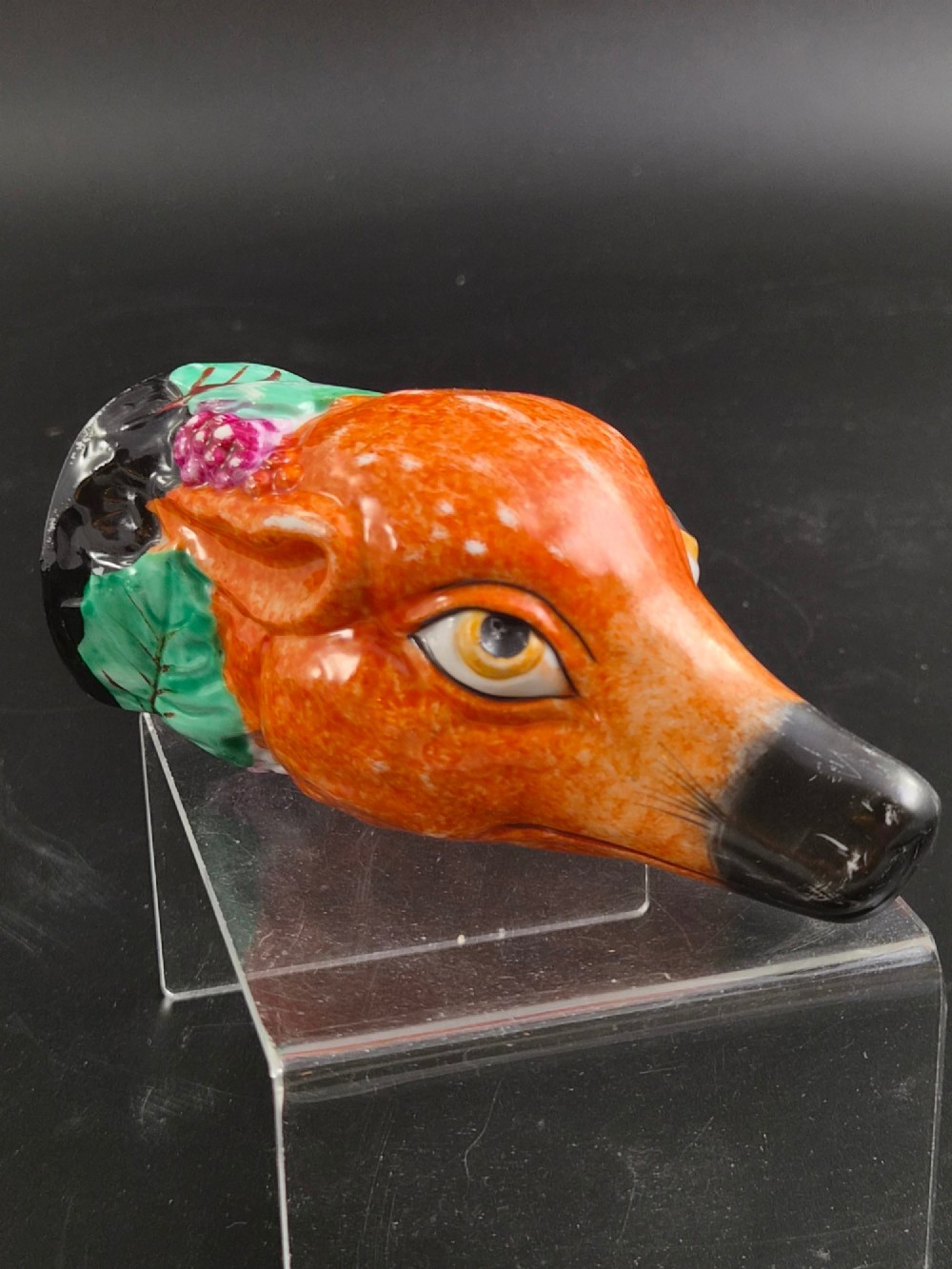 A 19th-century Royal Staffordshire porcelain stirrup cup molded in the form of a fox head with painted orange, black, green, and purple enamels. View III