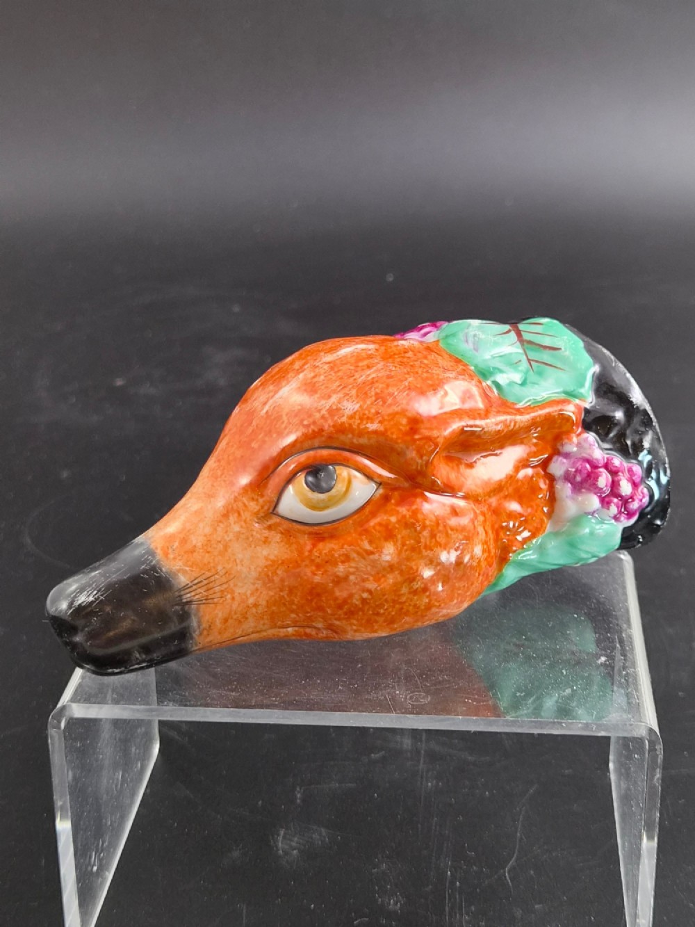 A 19th-century Royal Staffordshire porcelain stirrup cup molded in the form of a fox head with painted orange, black, green, and purple enamels. View VIII