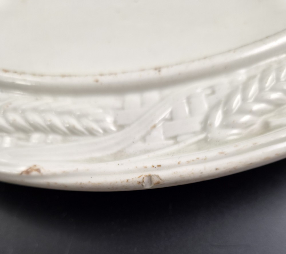 An off-white Victorian ironstone cheese dome and matching circular stand with molded relief lattice work and wheat sheaf motifs. View XIV