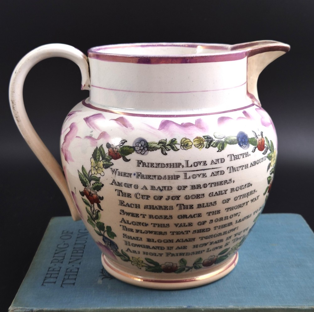 An antique cream earthenware jug decorated with pink splash lustre glaze and a central transfer print depicting the Iron Bridge over the Wear. View IV