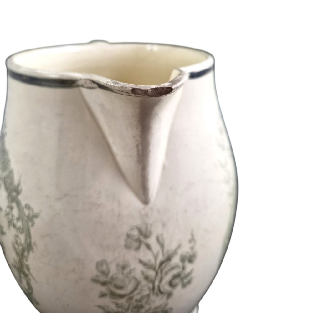 A Georgian Staffordshire creamware jug featuring transfer-printed olive-green Masonic iconography framed by a leafy scrollwork wreath. View XI