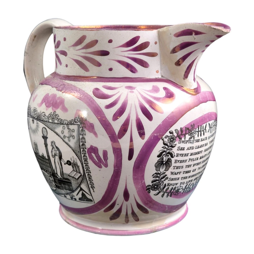 An antique white earthenware jug decorated with pink metallic lustre foliage borders and a black transfer-printed Masonic emblem featuring twin columns and symbolic motifs. View II