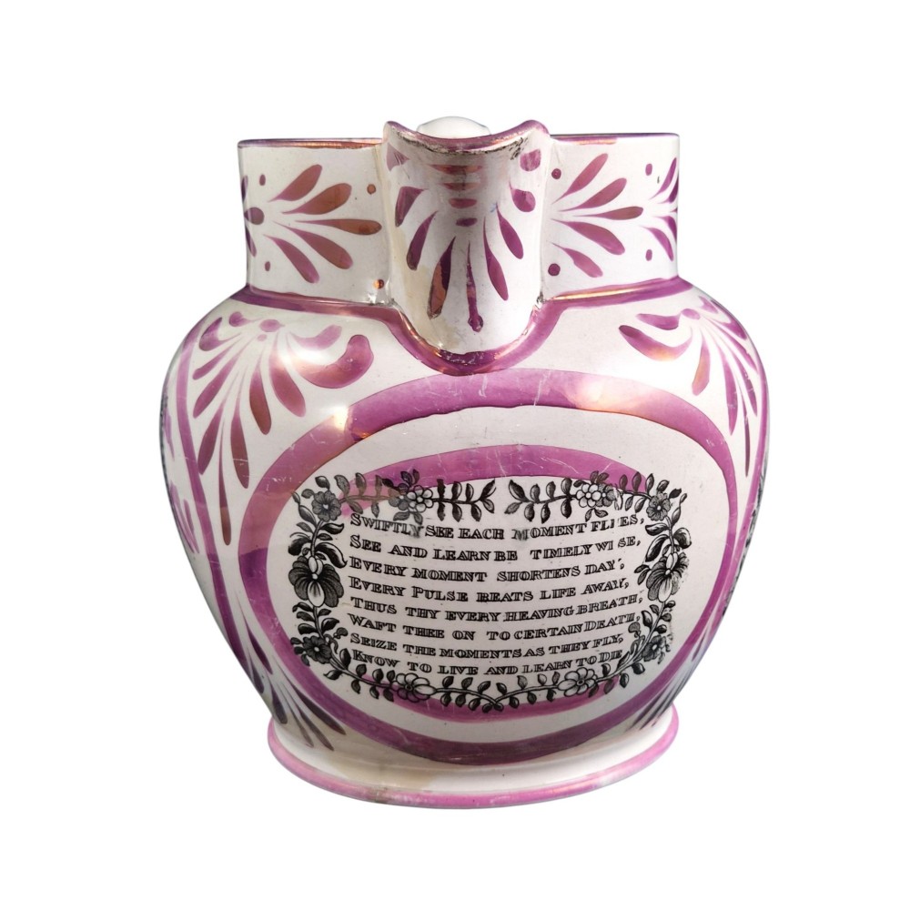 An antique white earthenware jug decorated with pink metallic lustre foliage borders and a black transfer-printed Masonic emblem featuring twin columns and symbolic motifs. View III