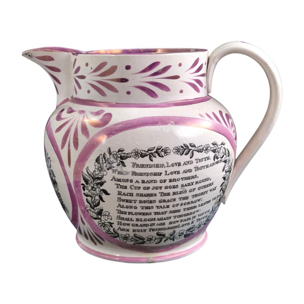An antique white earthenware jug decorated with pink metallic lustre foliage borders and a black transfer-printed Masonic emblem featuring twin columns and symbolic motifs. View V