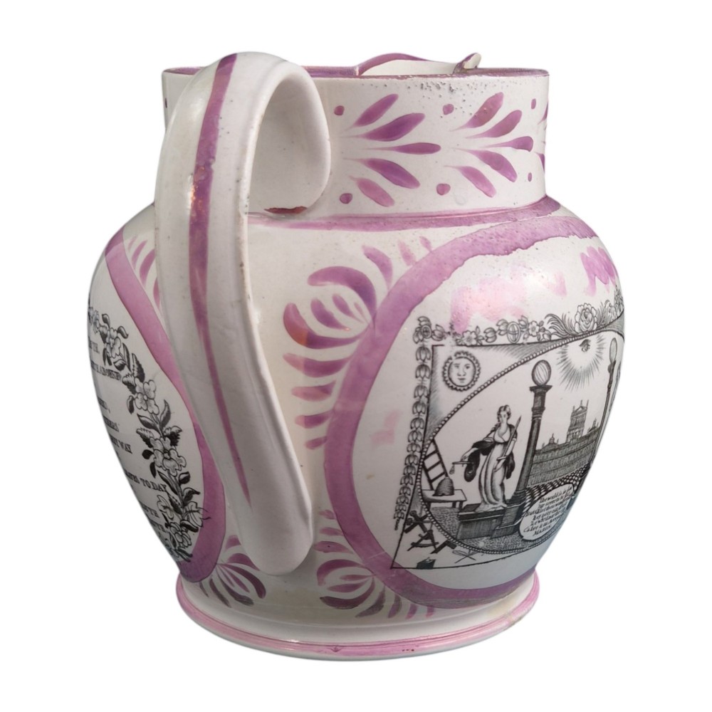 An antique white earthenware jug decorated with pink metallic lustre foliage borders and a black transfer-printed Masonic emblem featuring twin columns and symbolic motifs. View VII