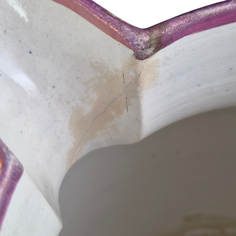 An antique white earthenware jug decorated with pink metallic lustre foliage borders and a black transfer-printed Masonic emblem featuring twin columns and symbolic motifs. View XI