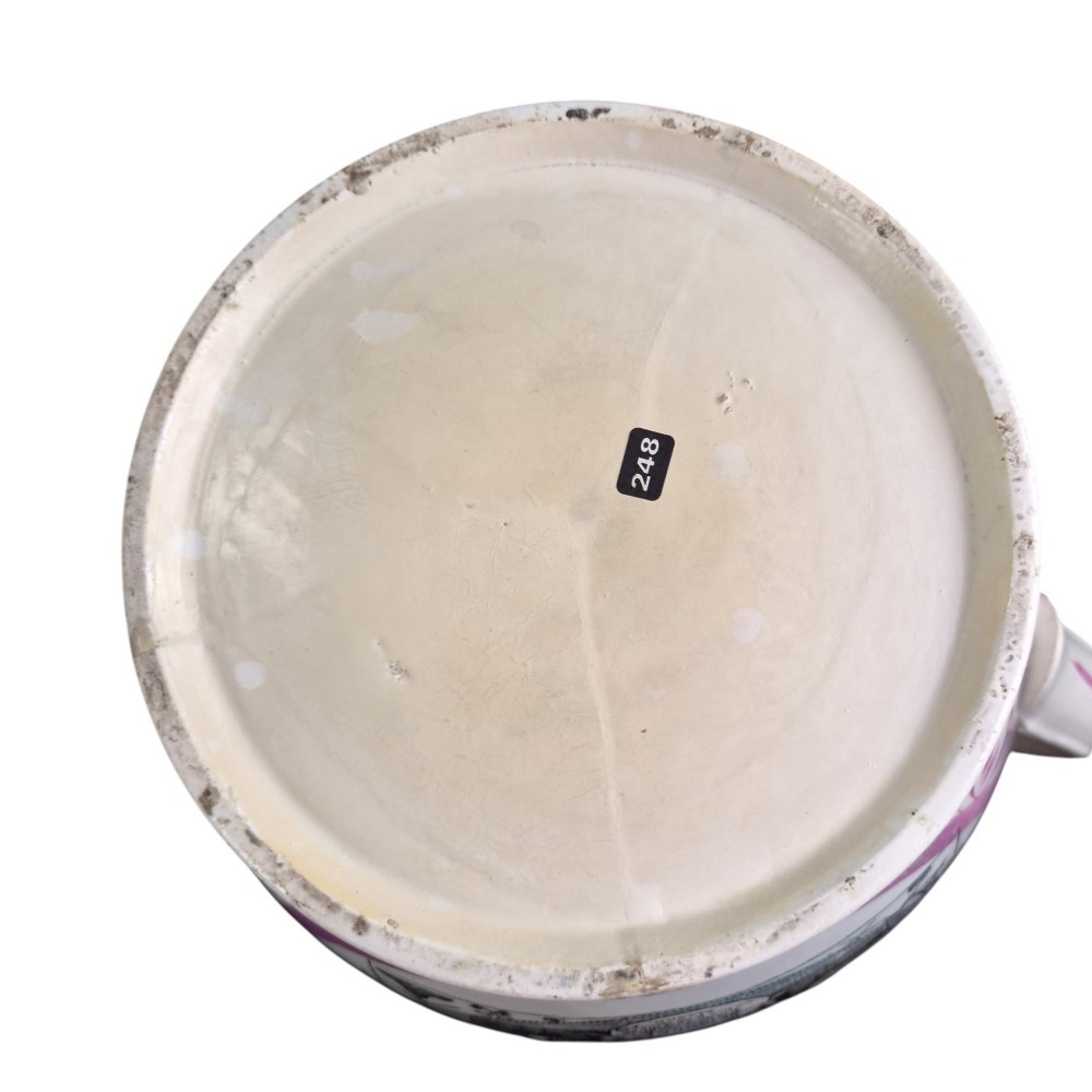 An antique white earthenware jug decorated with pink metallic lustre foliage borders and a black transfer-printed Masonic emblem featuring twin columns and symbolic motifs. View XII