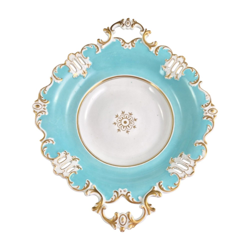 A Victorian Coalport bone china tazza featuring a turquoise border, central floral motif, gilded scroll accents, and a footed stem base. View X