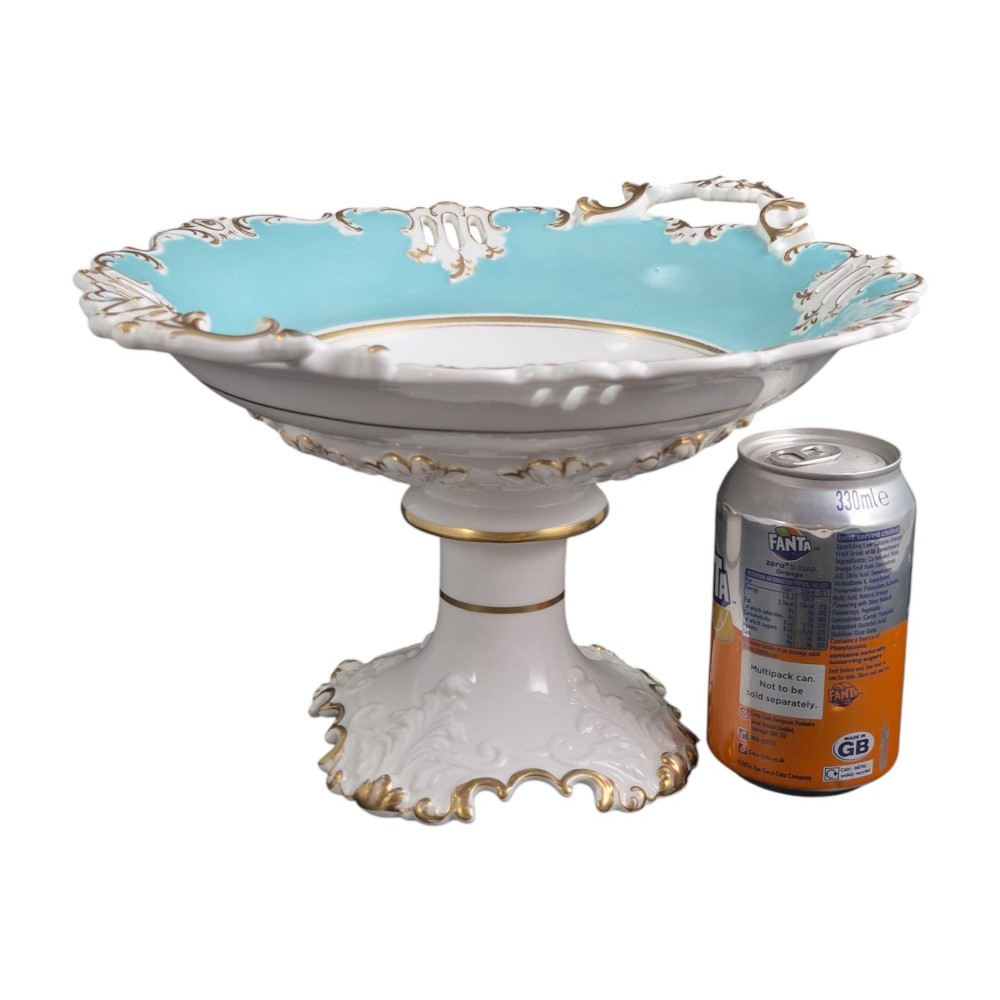 A Victorian Coalport bone china tazza featuring a turquoise border, central floral motif, gilded scroll accents, and a footed stem base. View XIII