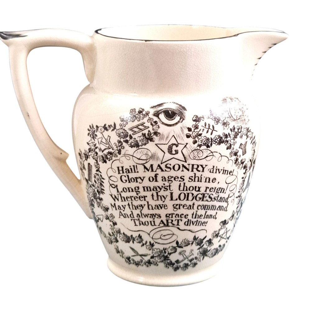A creamware ceramic jug featuring detailed black transfer prints of Masonic emblems, including classical columns, a beehive, and a coat of arms. View III
