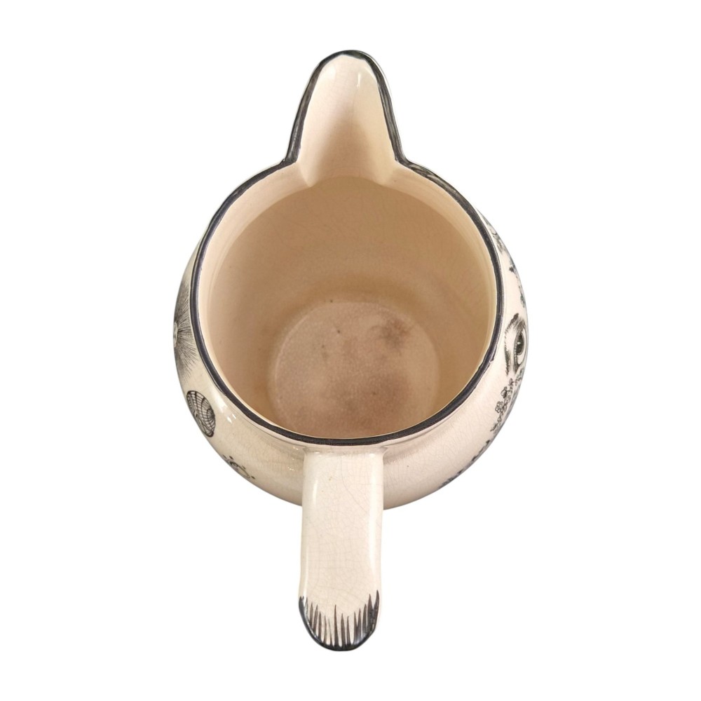 A creamware ceramic jug featuring detailed black transfer prints of Masonic emblems, including classical columns, a beehive, and a coat of arms. View VII