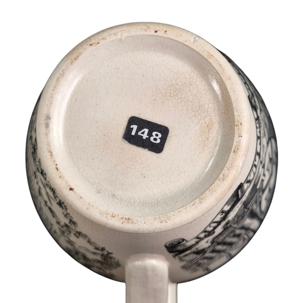 A creamware ceramic jug featuring detailed black transfer prints of Masonic emblems, including classical columns, a beehive, and a coat of arms. View VIII