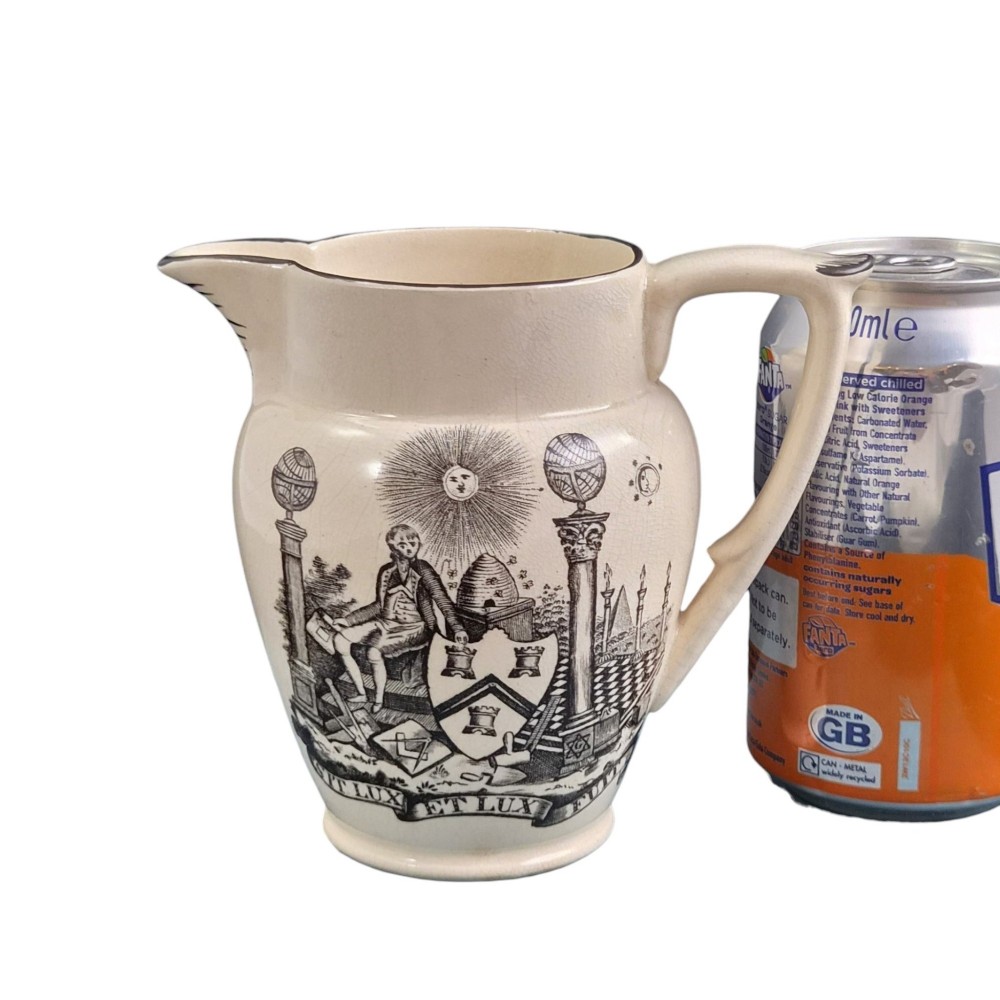 A creamware ceramic jug featuring detailed black transfer prints of Masonic emblems, including classical columns, a beehive, and a coat of arms. View IX