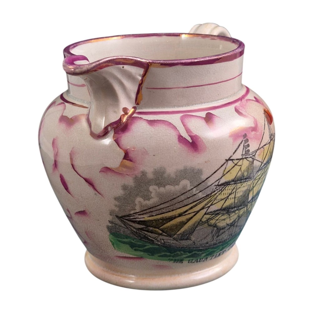 An antique cream earthenware jug featuring pink splash lustre decoration and a hand-coloured transfer print of Masonic coats of arms. View III