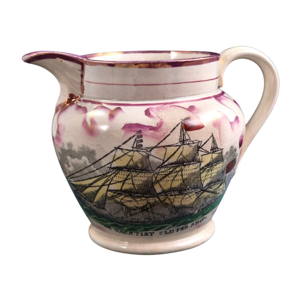 An antique cream earthenware jug featuring pink splash lustre decoration and a hand-coloured transfer print of Masonic coats of arms. View IV
